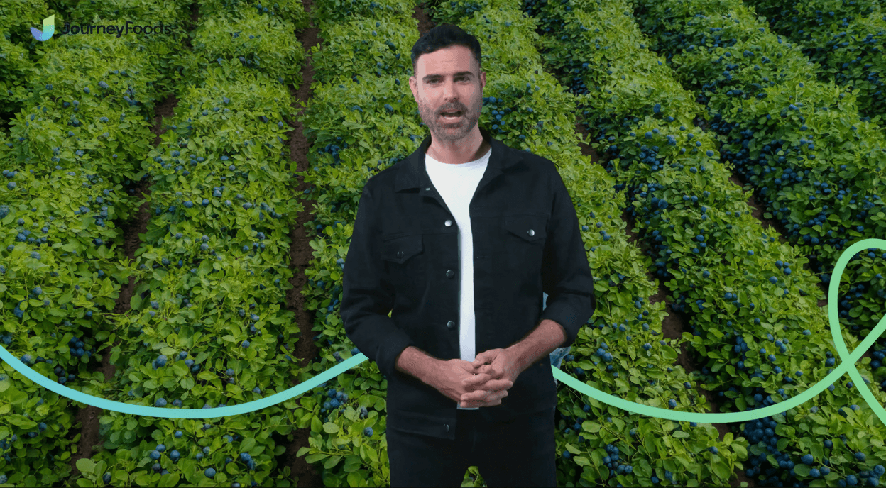 Journey Foods presenter in front of a green living wall